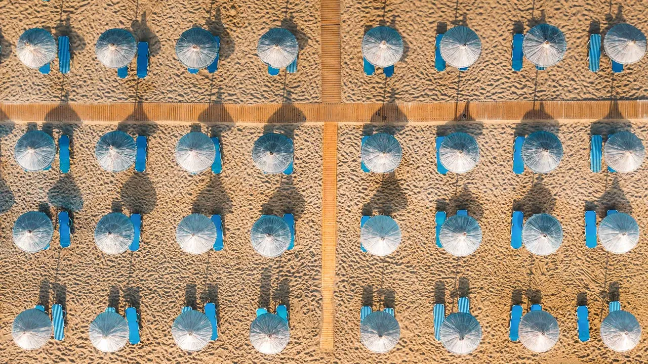Blue sunbeds on a sandy beach in Vai, Crete, Greece