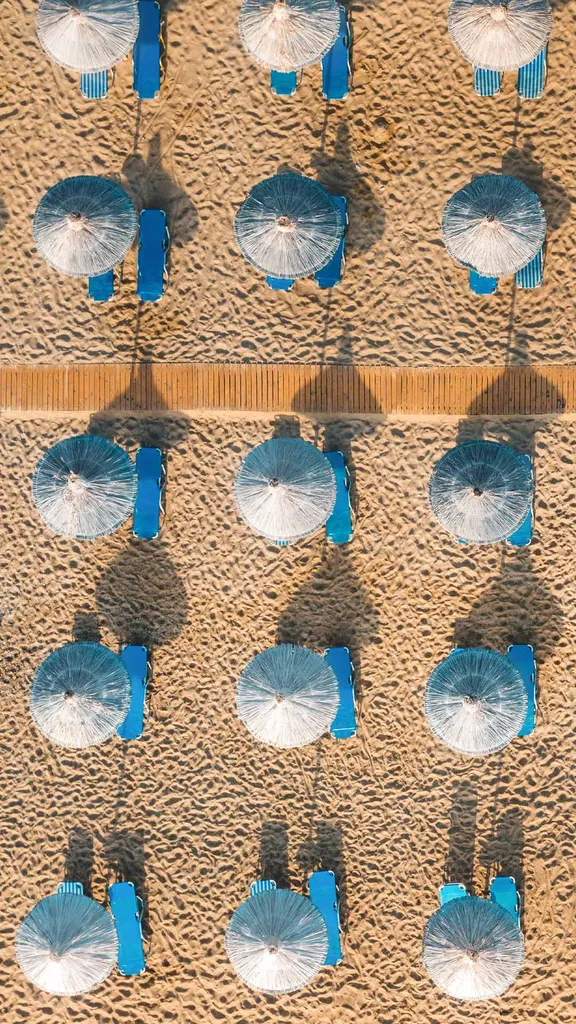 Blue sunbeds on a sandy beach in Vai, Crete, Greece